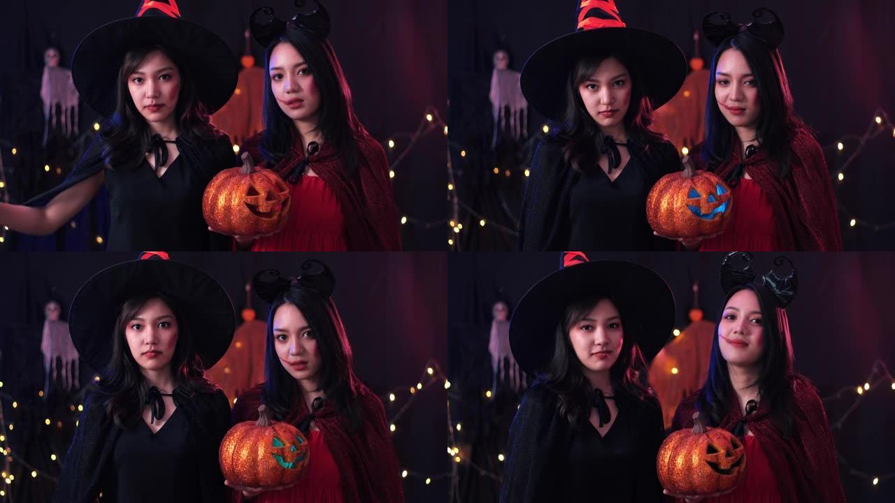 两名亚洲女子穿着万圣节服装，在黑暗的背景下看着相机
