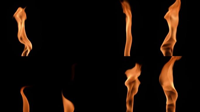 两个火焰交替点亮，并在黑色背景下发出橙黄色的火焰。真正的篝火、燃烧器或火炬在黑暗中燃烧起来。火光，危