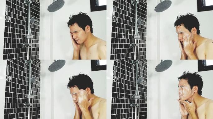 一个年轻人在浴室淋浴洗脸。