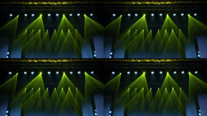 舞台灯光框架的动画。明亮闪亮的舞台灯闪烁运动娱乐聚光灯投影仪在黑暗中，绿色柔和的灯光聚光灯撞击在黑色