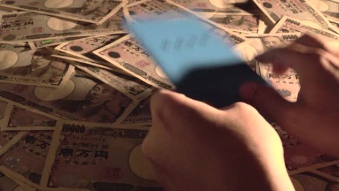拿起养老金簿。日本国民养老金簿和10,000日元账单