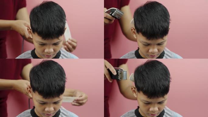 亚洲男孩在家由母亲理发
