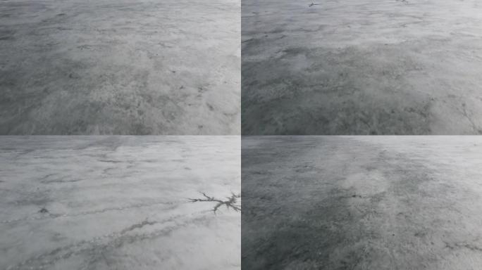 湖或河上冰上的无人机景观。在水上裂开并融化冰。