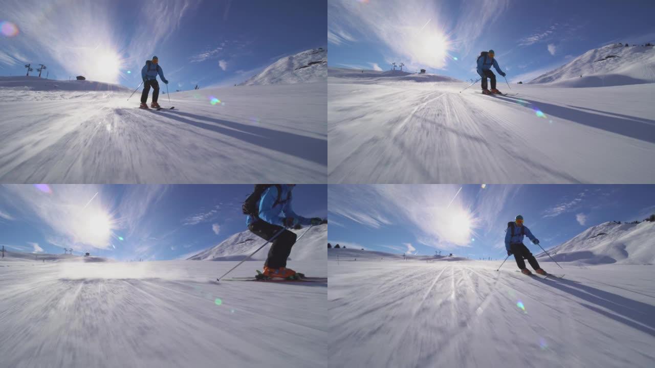 专业滑雪者在瑞士阿尔卑斯山的斜坡上滑雪。展开双手和滑雪。
