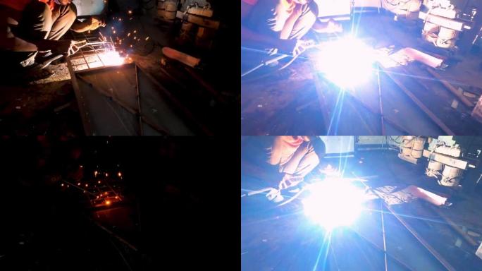 在车间工厂工作的焊工。金属焊工与电弧焊机一起工作，在磨损时在工厂焊接钢材。