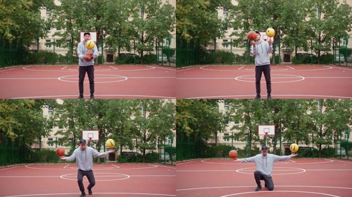 熟练的男子表演篮球自由泳技巧，双手食指旋转两个球，跪在室外球场上。年轻的男性自由式运动员在慢动作中做