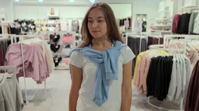 快乐的年轻女孩正在逛服装店。检疫后购物。