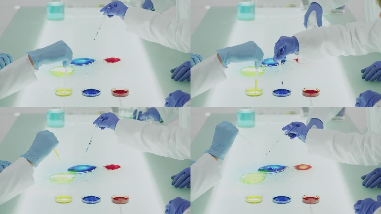 实验室教室: 科学家统一学习科学的孩子和老师。混合多色液体的实验