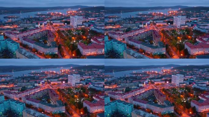 暮色中的摩尔曼斯克。俄罗斯暮色期间摩尔曼斯克市和城市港口的鸟瞰图