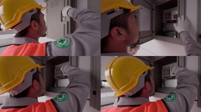 电工用手检查电气柜控制面板中的电气，切换断路器箱。