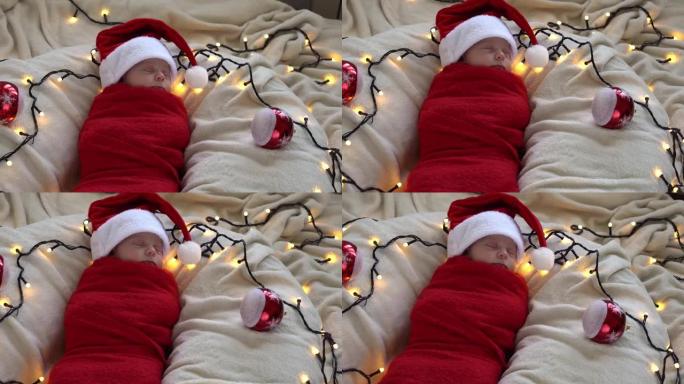 顶视图肖像生命的第一天新生儿可爱有趣的睡在圣诞老人帽子包裹在白色花环背景的红色尿布。圣诞快乐，新年快