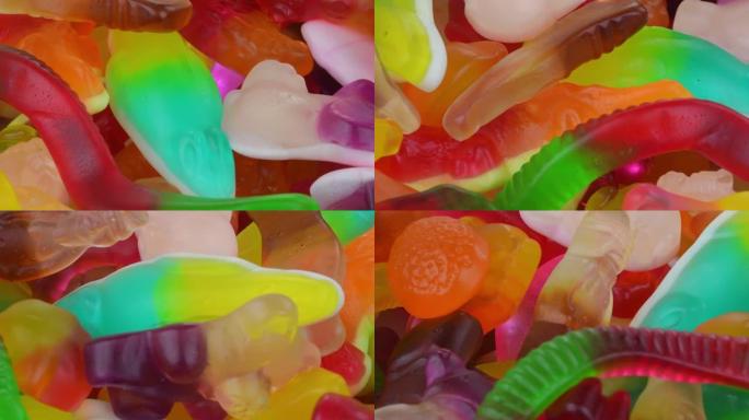 糖果糖果背景。什锦彩色混合糖果。五颜六色的美味糖果转向俯视图。果冻糖果。全画幅背景。旋转。从上方观看