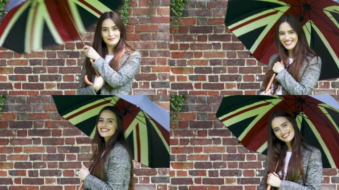 一名年轻女子打开英国国旗伞，在肩膀上旋转，看着相机，微笑着