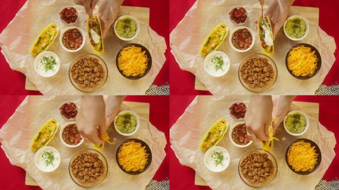 餐桌上的传统墨西哥食物，德克萨斯墨西哥美食。烹饪肉玉米卷或墨西哥卷饼，放入酸奶油和胡萝卜。番茄汤配玉