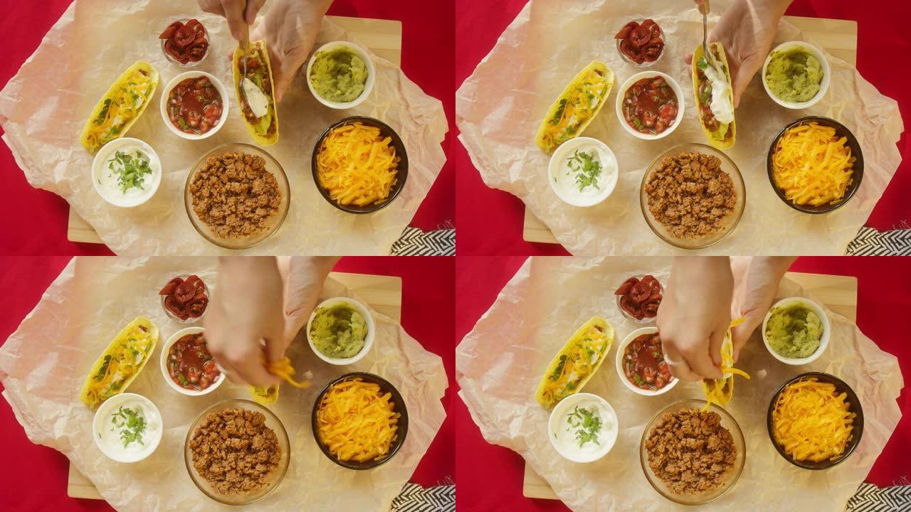 餐桌上的传统墨西哥食物，德克萨斯墨西哥美食。烹饪肉玉米卷或墨西哥卷饼，放入酸奶油和胡萝卜。番茄汤配玉