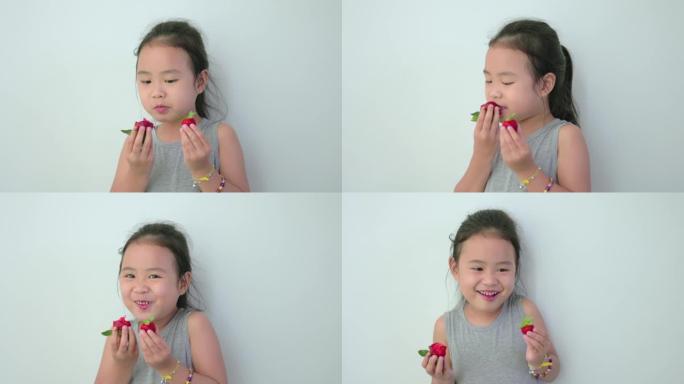 吃草莓的亚洲女孩。