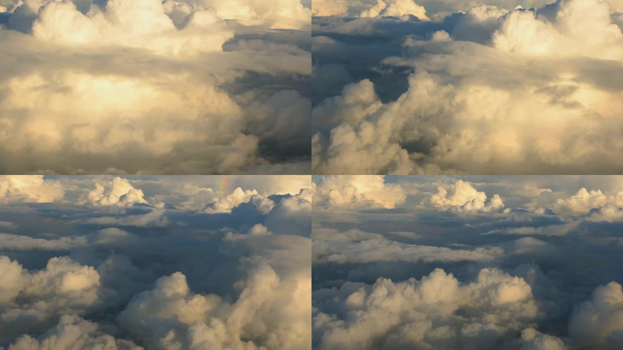 在阳光明媚的早晨，从飞机窗户可以看到平流层上方的蓝天和云海