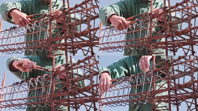 手准备金属框架，为钢筋混凝土建筑结构固定钢筋。建筑工地上不可识别的建筑工人。
