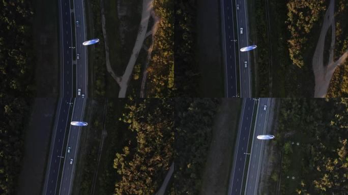 在高速公路上飞行的发动机动力滑翔伞的俯视图