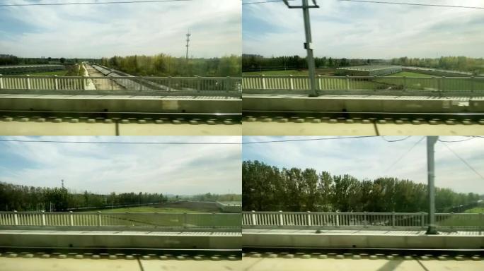 看着火车上的窗户，路过城市郊区的农场
