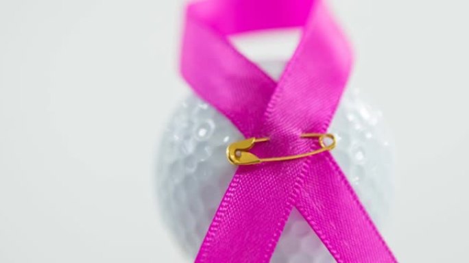粉红色丝带，安全别针和白色背景上的高尔夫球的动画