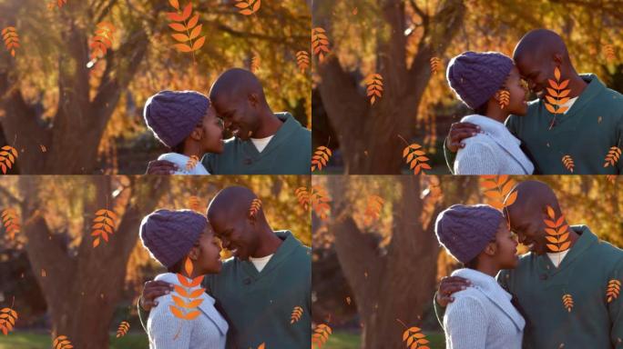 橙色秋叶的动画落在公园里快乐的非洲裔美国夫妇上