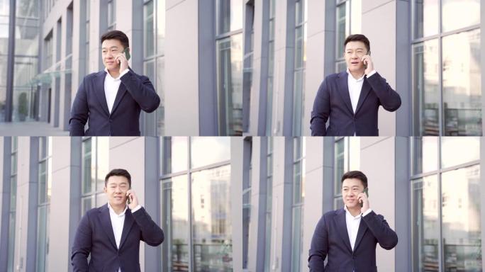 肖像成功的年轻自信商人谈话背景市中心的现代办公楼。