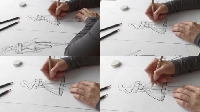 服装设计师在工作场所的纸上画草图。艺术家为这件衣服创造了一个模型。时尚概念。