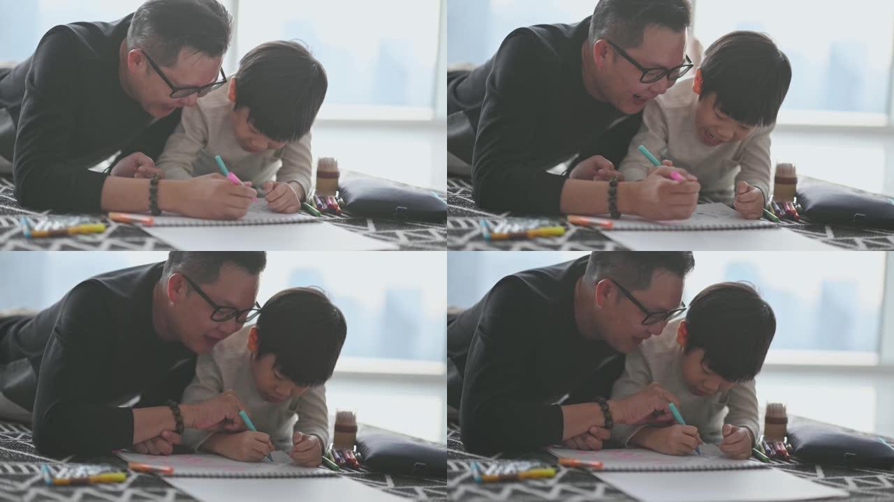 亚洲华裔年轻家庭父子周末在客厅公寓享受在家画画的时间