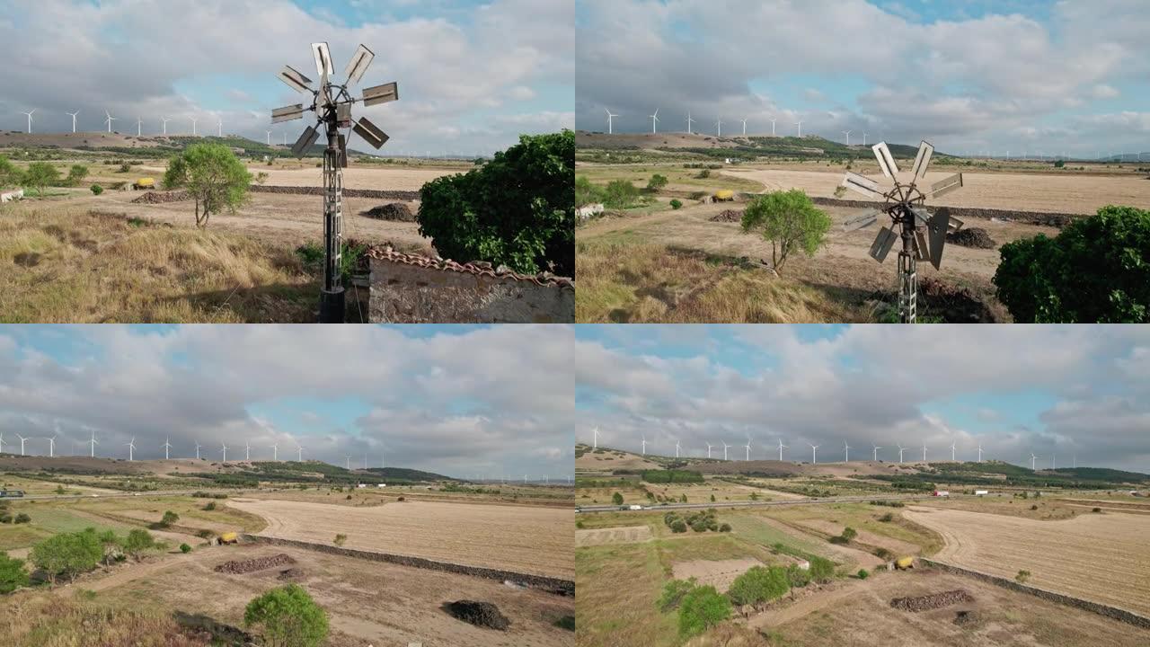 农场的后院风车和背景中的许多风电场。小型风车和风电场之间的对比，小规模电力生产 ..