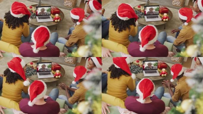 拥有圣诞老人帽子的多元化家庭使用笔记本电脑进行圣诞节视频通话，屏幕上有微笑的女人