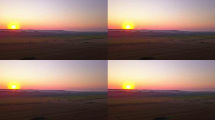 无人机在日出时在中西部农村农场的麦田上方射击