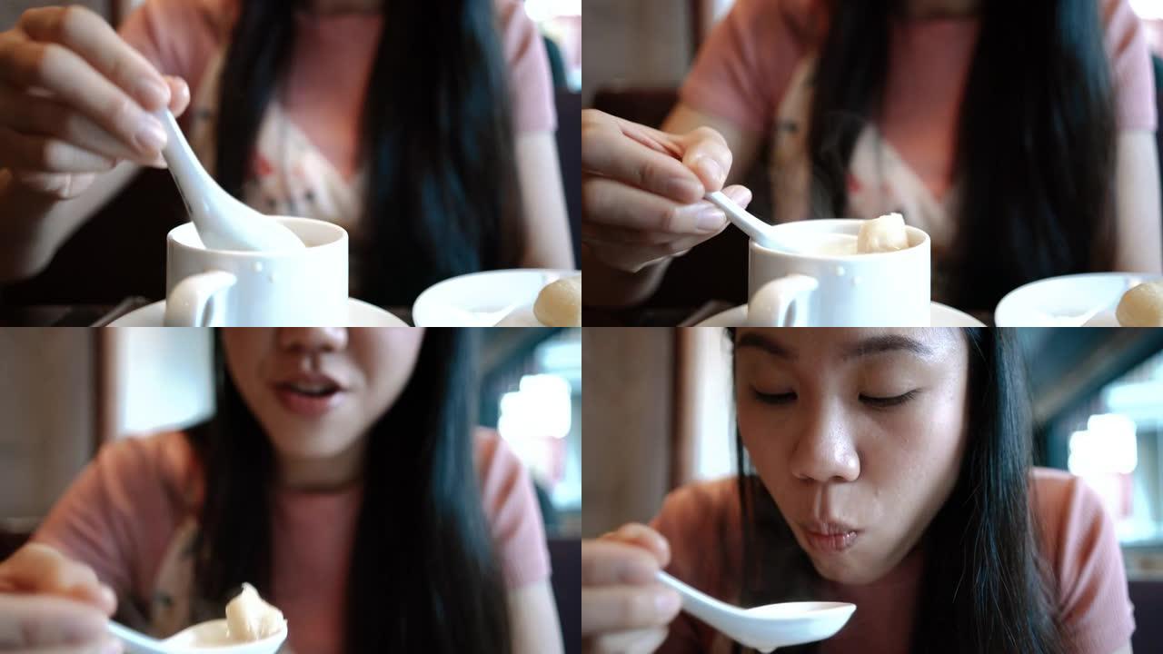 一个年轻女人在吃食物的特写镜头。