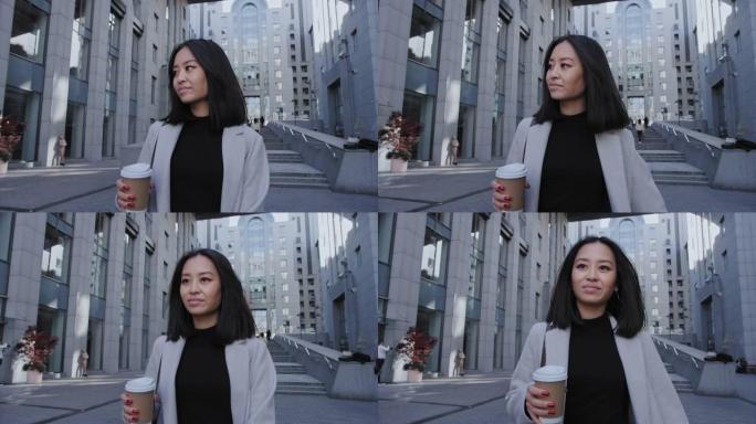 自信的年轻亚洲女商人在办公中心喝咖啡走自己的路