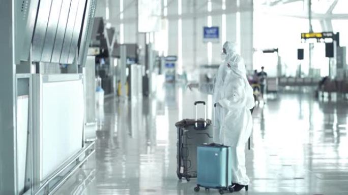 新型冠状病毒肺炎大流行期间，机场的4k年轻夫妇穿着干净的西装，戴着防护面罩