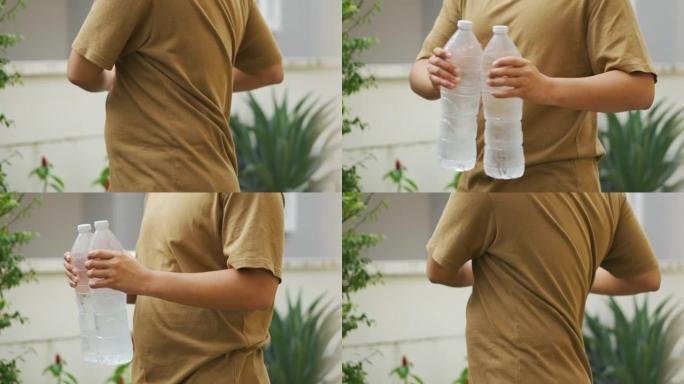 亚洲男子使用一瓶水进行锻炼