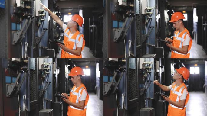 工程师在MDB面板上使用数字平板检查和检查他们与电气配电板一起工作，以检查主配电板工厂工作的电压范围
