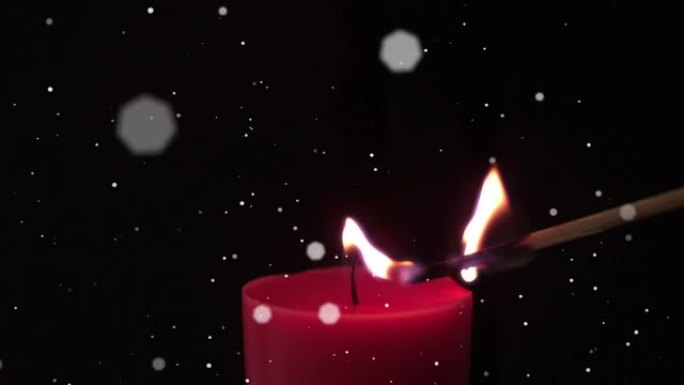 漂浮在火柴棒上的白色斑点在黑色背景下点燃红色蜡烛