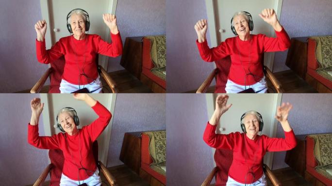 快乐的微笑搞笑的高级女人戴着耳机在家里用手机跳舞