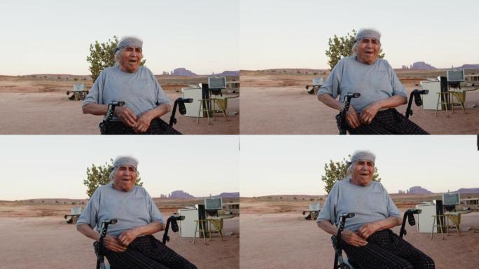 非常年迈的美国原住民纳瓦霍人坐在轮椅上，黄昏时在亚利桑那州纪念碑谷或犹他州的户外享受