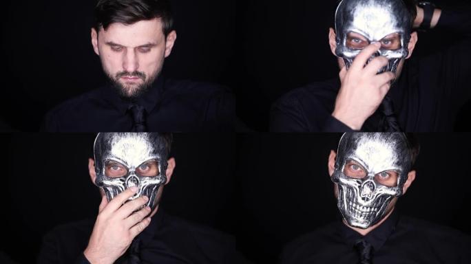 该名男子戴上灰色骷髅面具，并将其调整在脸上