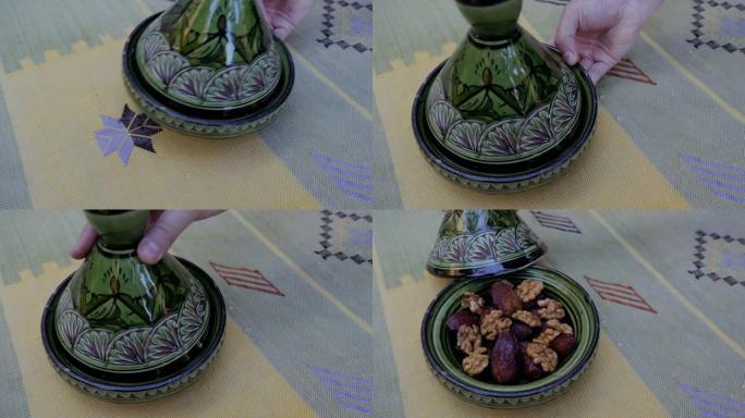 日期和核桃在装饰绿色的tajine (tajine) 中，在手工制作的传统摩洛哥仙人掌丝绸 (Sab