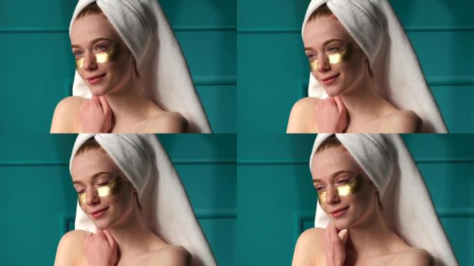 可爱的雀斑姜女人洗澡后戴着金色眼罩，肩膀空着