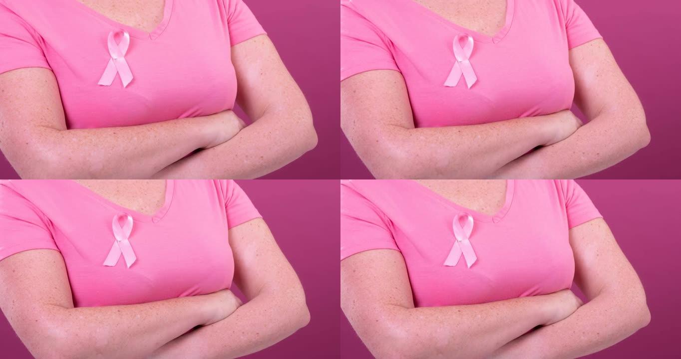 白种人妇女的腹部与交叉双臂戴粉红癌症意识丝带的视频
