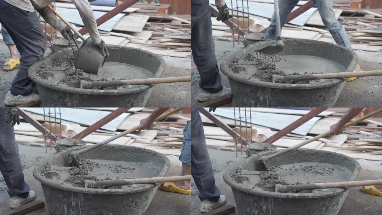 工人在施工现场搅拌和浇注水泥。
