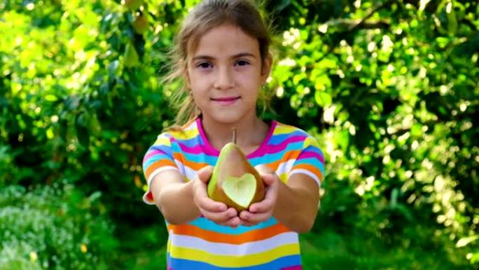 孩子在花园里吃梨。选择性聚焦。