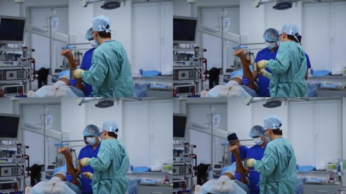 手术室的医疗程序。医生在手术前准备病人的腿。在现代诊所工作的医务人员。