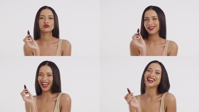 一个美丽的年轻女人涂红色唇膏的4k视频片段