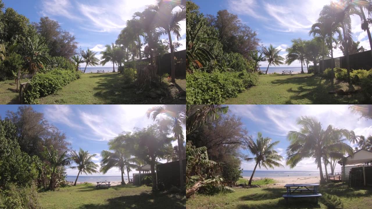后院带野餐桌到海滩边步行近距离放大视野在阳光明媚的日子里眺望大海，蓝天阳光明媚的阳光椰子树平潮波位于