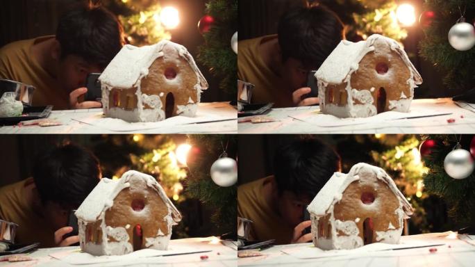 亚洲男孩在姜饼屋拍照结束后，圣诞节庆祝生活方式。